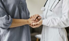 covid-recovery-center-female-doctor-holding-older-patient-s-hands